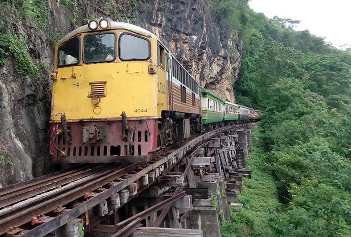 Old style train running between the Kwai River Bridge and Nom Tok Station